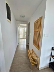 a hallway with a staircase and a room with a tv at Bella Vista Blu apartman s pogledom na more, Povljana, otok Pag in Povljana