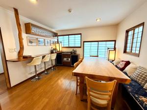 a living room with a wooden table and a couch at Edo-Ko House in Myoko +24 photos