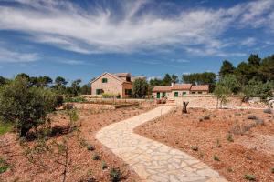 a stone walkway leading to a house at Villa Miranda Hvar in Stari Grad