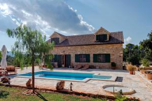 a house with a swimming pool in the yard at Villa Miranda Hvar in Stari Grad