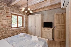 a bedroom with a bed and a television in a room at Villa Miranda Hvar in Stari Grad +68 photos