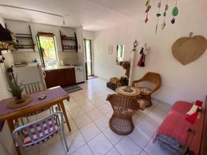 a kitchen with a table and chairs in a room at House Kornati Robinzon in Sit