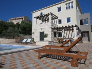 a house with a swimming pool next to a building at House Sandra in Lumbarda