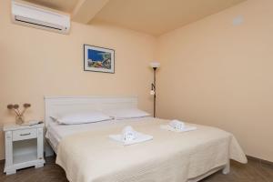 a bedroom with a bed with two towels on it at House Sandra in Lumbarda +23 photos