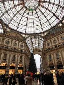 a christmas tree in a building with a glass ceiling at Rosso di Piera Rooms in Arluno