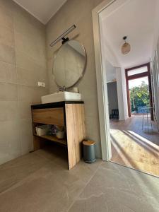 a bathroom with a sink and a mirror at House Pavicic in Poljica +9 photos