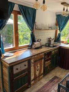 a kitchen with a wooden counter top in a room at Csillagfény Házikó in Nagymaros