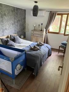 a bedroom with a blue and white bed and a window at Csillagfény Házikó in Nagymaros