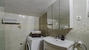 a bathroom with a sink and a washing machine at Villa Naty with Whirlpool by Villas Guide in Vela Luka +36 photos