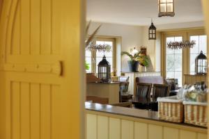 a yellow door in a room with chairs at Hotel De Brabantse Biesbosch in Werkendam