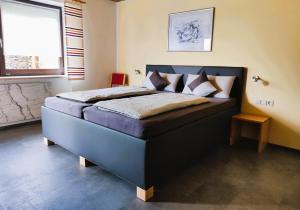 a bedroom with a blue bed with pillows on it at Ferienwohnung Seidl in Waffenbrunn
