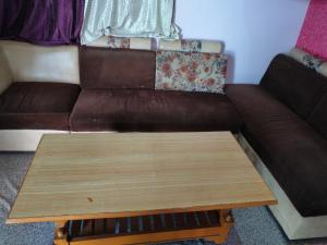 a living room with a couch and a coffee table at Naveen Homestay in Amroha