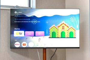 a tv screen with a christmas house on it at The Top名駅 in Nagoya