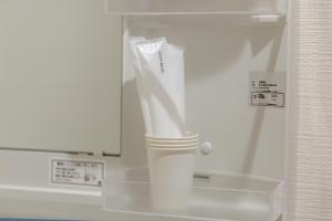 a bathroom with a mirror and a white toothbrush at The Top名駅 in Nagoya +32 photos