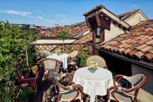 two tables and chairs on a balcony with a roof at Antica Locanda al Gambero in Venice