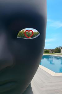 a heart on a plate next to a swimming pool at Hotel Ohana in Rome