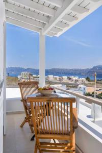 a table and two chairs on a balcony with a view at Casa View in Akrotiri