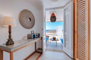 a kitchen with a table with a microwave and a balcony at Casa View in Akrotiri