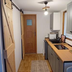 a kitchen with a wooden door and a counter top at Laguna Turawa in Turawa +10 photos