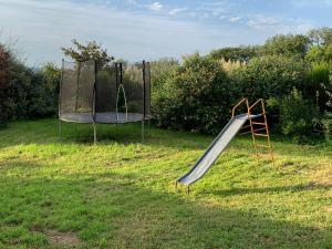 an empty playground with a slide in the grass at Serenane in Saint-André-de-Najac