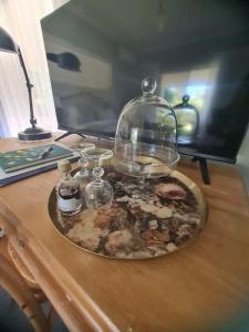 a plate of food on a table with a glass dome at Birchwood Gardens Bed and Breakfast in Narrikup