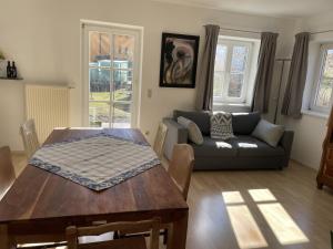 a living room with a table and a couch at Maisonette Giggi in Peiting