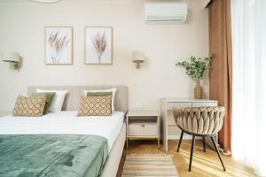 a small bedroom with a bed and a chair at Sand Boho Harmony Luxury - AC Parking & Balcony - by UniqueRent in Wrocław
