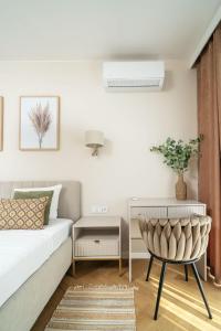 a bedroom with a bed and a chair at Sand Boho Harmony Luxury - AC Parking & Balcony - by UniqueRent in Wrocław