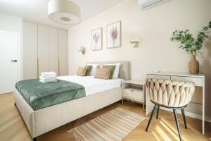 a bedroom with a bed and a chair and a desk at Sand Boho Harmony Luxury - AC Parking & Balcony - by UniqueRent in Wrocław