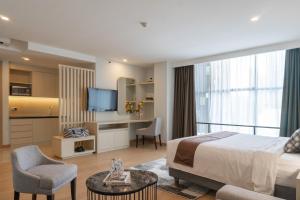 a hotel room with a bed and a desk and chair at Avissa Suites in Jakarta
