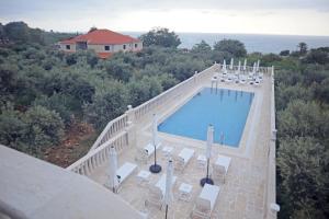 an overhead view of a swimming pool on a house at Villa Olivera Hotel in Tḩūm at Taḩtā +13 photos
