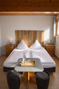 a bedroom with a large bed with a table and chairs at Pension Bergseeblick in Titisee-Neustadt