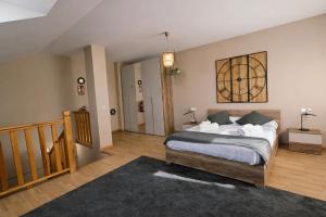 a bedroom with a large bed and a staircase at Casa Vacacional El Alisu in Arriondas