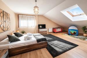 a bedroom with a large bed and a tv at Casa Vacacional El Alisu in Arriondas