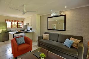 a living room with a couch and a kitchen at Baywater Village by MyResorts in Sedgefield +20 photos