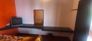 a room with a television and a mirror at AFIYA HOME STAy in Kodaikānāl