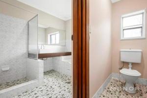 a bathroom with a shower and a toilet and a sink at Room 00 in Baulkham Hills