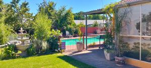 a backyard with a swimming pool and a garden at SONHOS dreams Self catering Garden Cottages in Bloemfontein