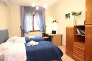 a hotel room with two beds and a desk at VicoStay di Casa Stella in Vico Equense