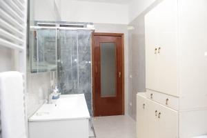 a white bathroom with a sink and a shower at VicoStay di Casa Stella in Vico Equense +22 photos