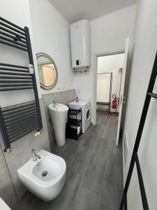 a bathroom with a sink and a toilet and a mirror at Arcobaleno in Turin +7 photos
