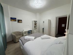 a bedroom with a bed with two towels on it at Arcobaleno in Turin