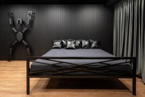 a black bedroom with a bed with black walls at BDSM Play Apartments in Vilnius +9 photos