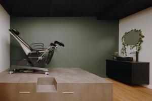 a room with a gym with a bench and a mirror at BDSM Play Apartments in Vilnius