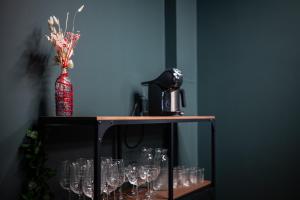 a table with wine glasses and a red vase at BDSM Play Apartments in Vilnius
