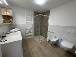a bathroom with a shower and a toilet and a sink at Casa Marì by Holiday World in Sulzano +23 photos