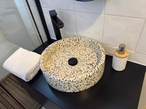 a bathroom sink with a leopard print on a counter at LE PANCAUT- Chaleureux - Hyper Centre in Mont-de-Marsan