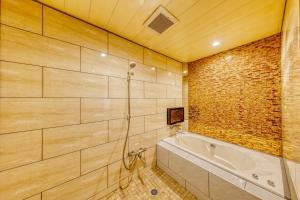 a bathroom with a shower and a tub at HOTEL ATLANTIS IKUTAMA -Adult Only in Osaka