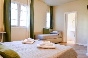 a bedroom with a bed with towels on it at Agriturismo De Ferrari in Onzo +32 photos