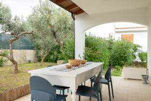 a white table and chairs on a patio at Brezza marina in Mola di Bari